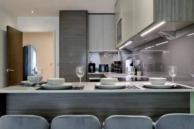 Modern kitchen with island set for dinner